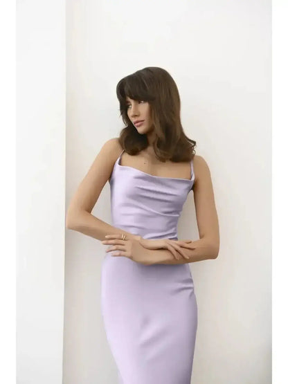 Elegant model wearing a sleek lavender satin Whisper Midi Dress with a draped neckline.