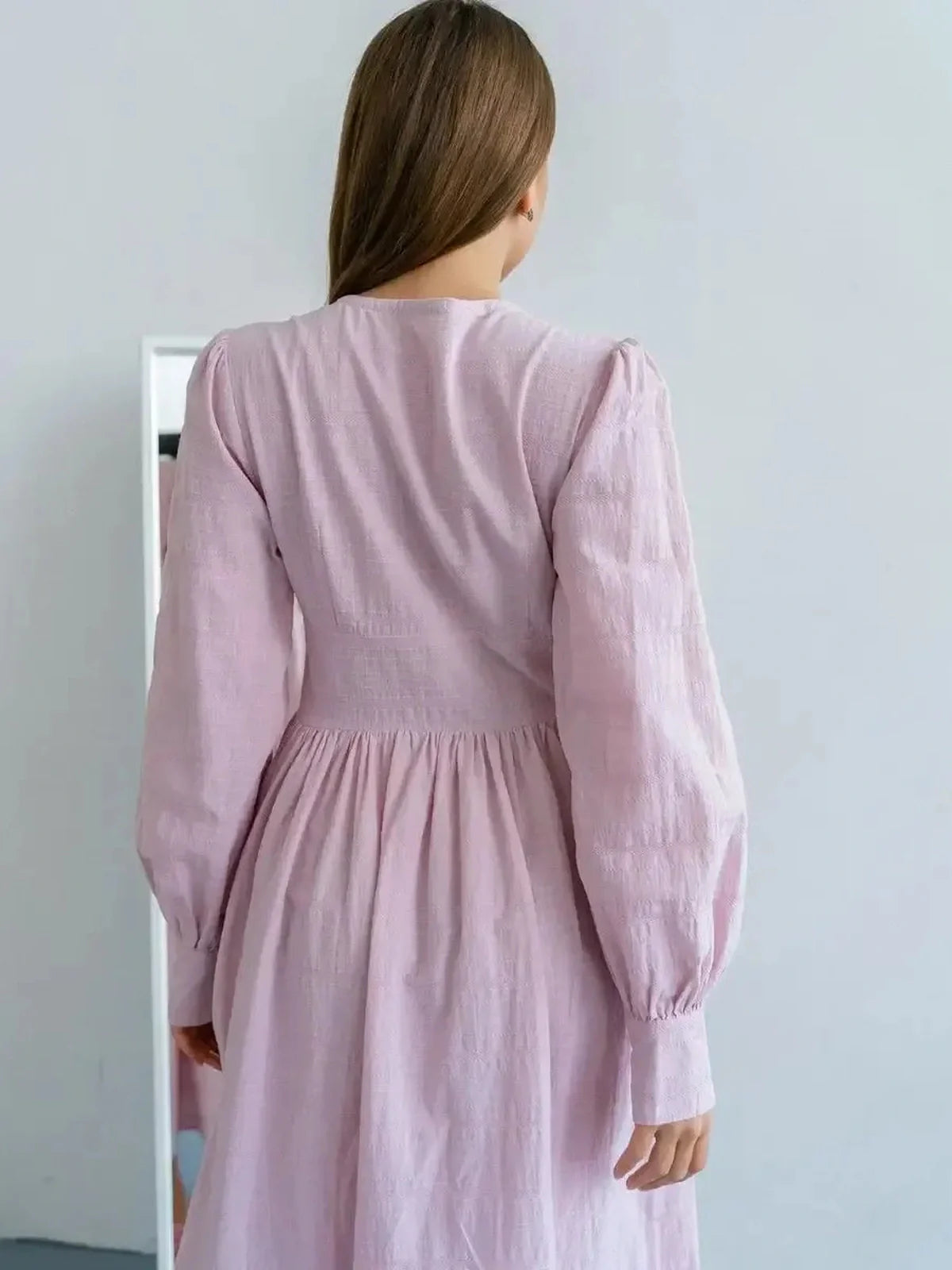 Back view of the Willow Grace Maxi Dress showcasing elegant sleeves and cinched waist in soft pink cotton.