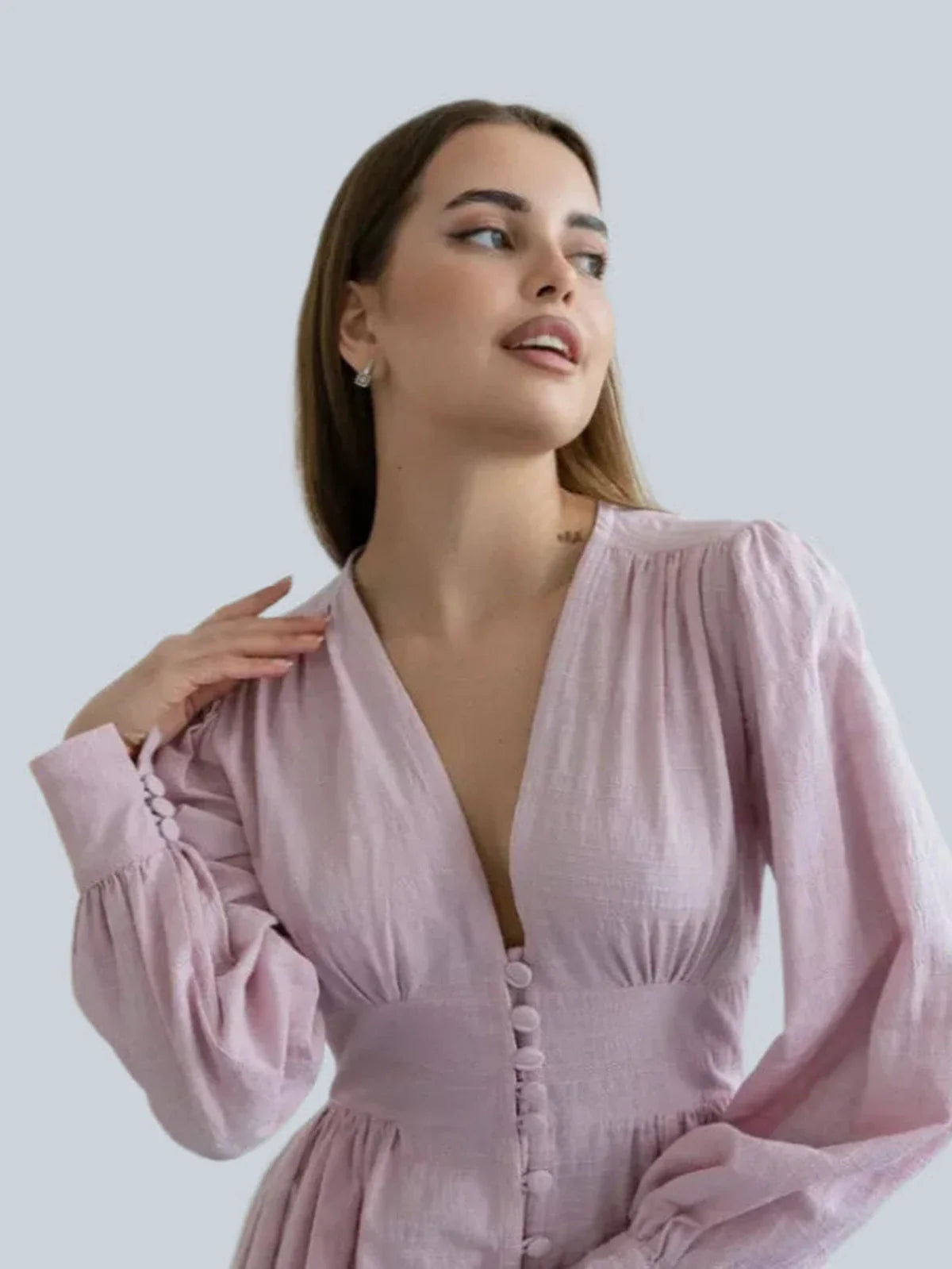 Model wearing the Willow Grace Maxi Dress, showcasing its elegant pink fabric and plunging neckline.