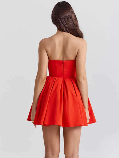 Back view of a women’s red mini dress with a pleated skirt and corset bodice, perfect for summer parties and formal events.