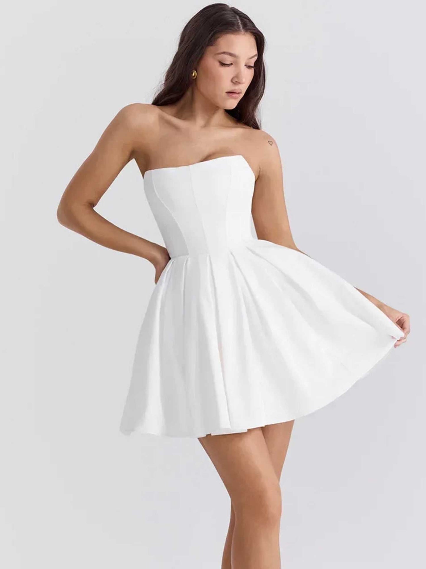 Zara mini dress in white featuring a strapless design and voluminous pleated skirt, perfect for summer and wedding guests.