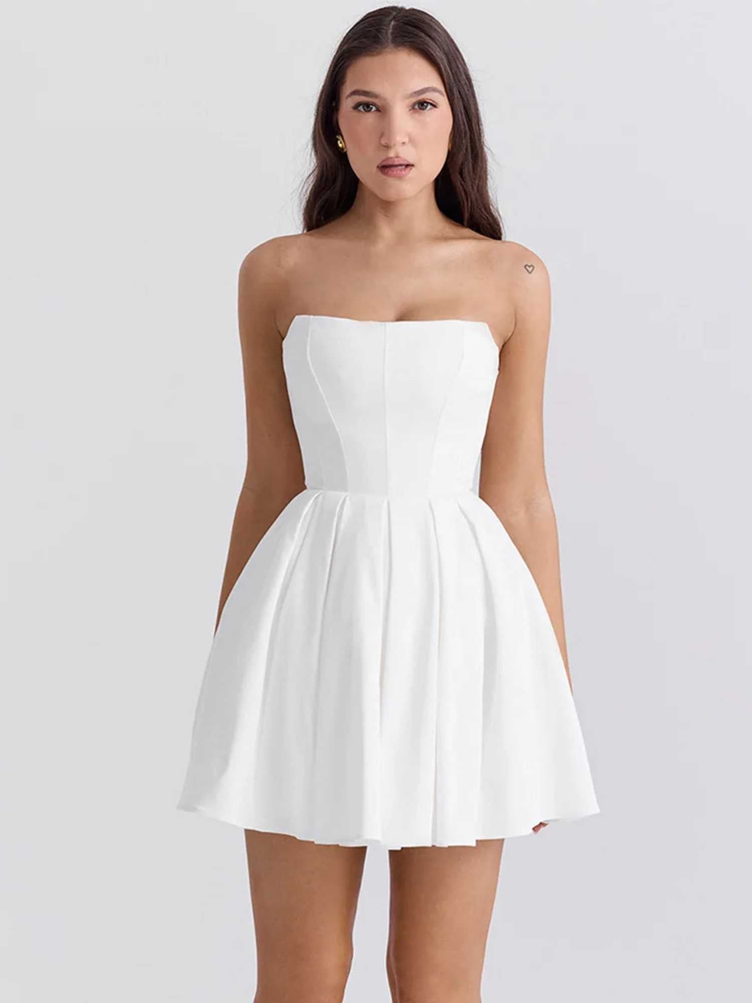 Elegant white mini dress with a strapless sculpted bodice and voluminous pleated skirt, perfect for summer events.